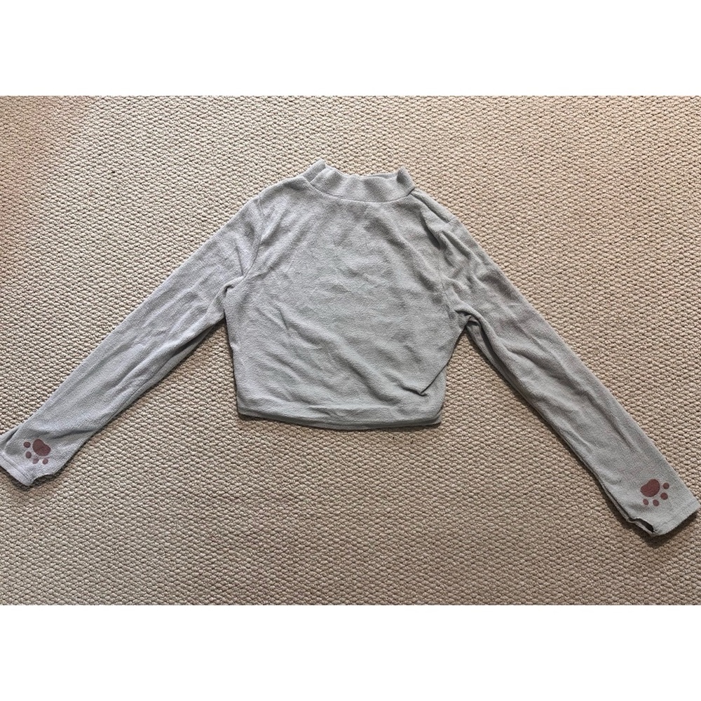 Medium light grey turtleneck with cat paws and a thumb hole.